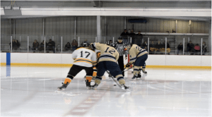 Sophomore forward Dan Merz takes the opening faceoff against Wooster – Photo by PJ Dumnich